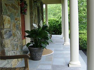 Cut bluestone porch veneered over top old, concrete porch with natural stone veneer on the house